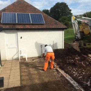 Demolishing remains of wall