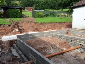 dug out area for steps to garden can be seen behind new brickwork