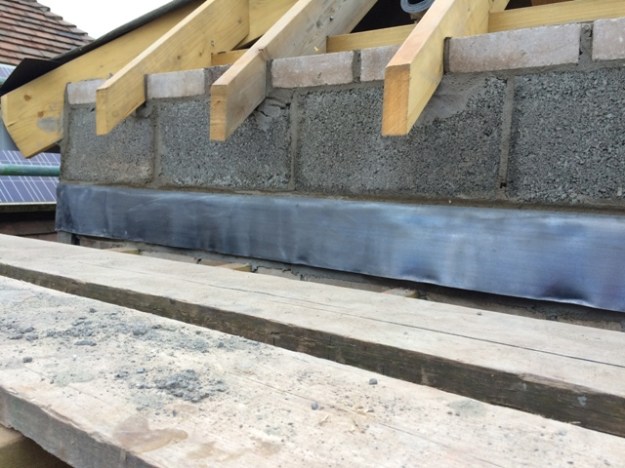 lead-inserted-into-roof-this-will-go-over-fibre-glass-board-double-wall-here-completed-between-rafters
