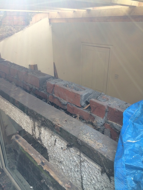 view-from-ladders-over-window-into-old-small-bedroom-with-ceiling-removed