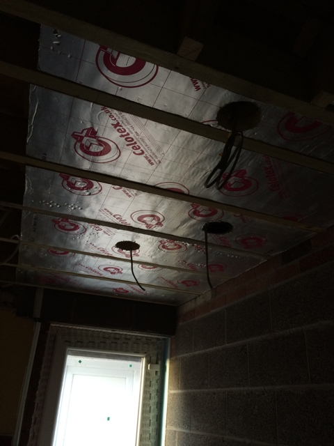 beginning-of-celotex-insulation-between-roof-and-beams-in-utility-room-cut-around-extractor
