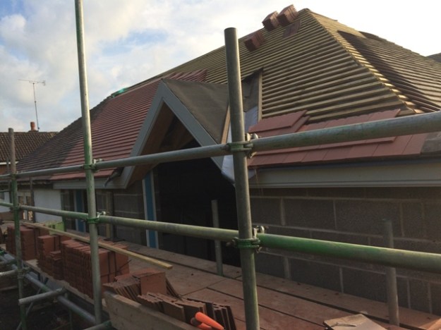 close-up-of-tiling-in-progress-through-scaffolding