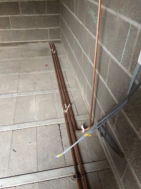 gas-and-water-supply-pipes-partly-installed-for-new-kitchen-through-new-wall