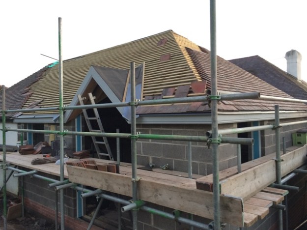 work-today-on-roof-tiles-on-righthand-side-roof-felt-on-peak-over-patio-doors-and-lead-in-valleys