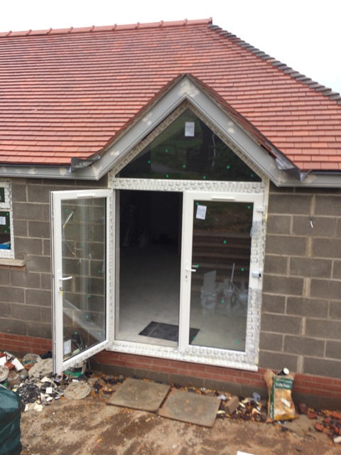 patio-doors-and-triangular-glass-fitted-above