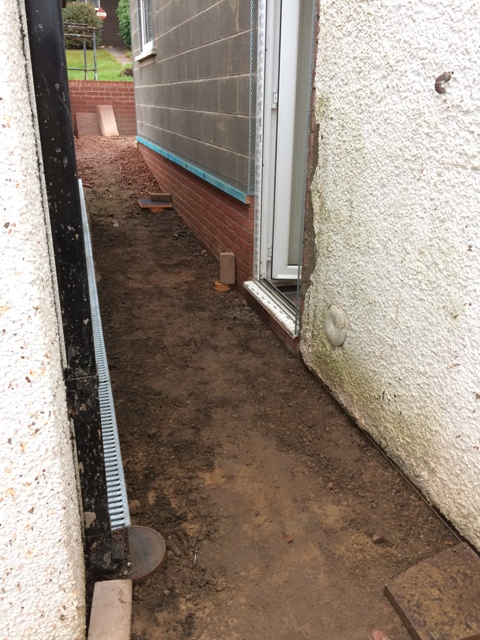 aco-drains-put-in-today-down-the-side-of-the-garage-ground-built-up-to-provide-a-downward-flow-and-ramp-away-from-house-and-to-stop-water-going-into-the-garage
