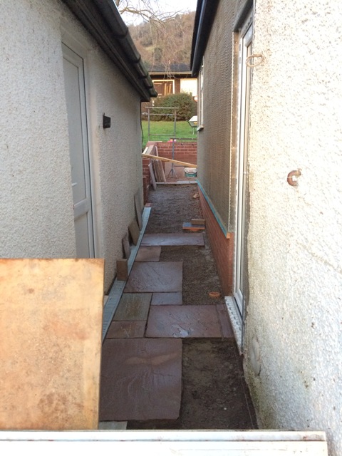 walkway-between-new-kitchen-an-garage-slabs-being-laid-also-scratch-coat-on-new-kitchen-outside-wall