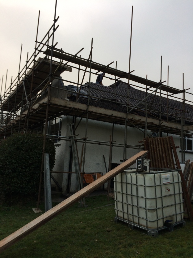 builder-cutting-away-roof-ready-for-beam-to-go-into-house