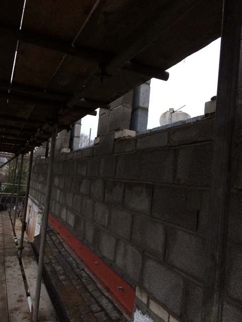 view-from-the-right-hand-side-of-house-steel-beams-in-brown-now-at-the-bottom-of-the-wall