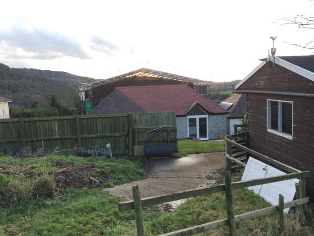 view-of-back-of-house-new-kitchen-and-canopy-visible-over-the-top-of-main-house-pic-2
