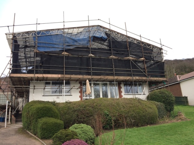 View of the house with new front doors and windows from a slightly different angle