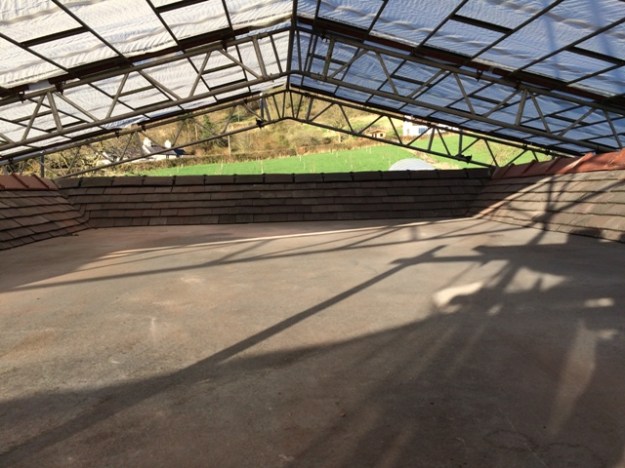 View over the top flat roof with ridge tiles now back on, and new ones over the gables